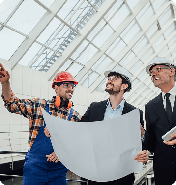 Engineers reviewing blueprints at construction site